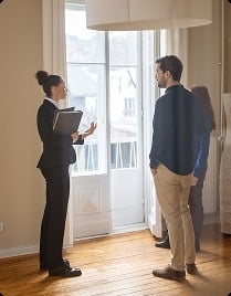 An agent showing an apartment to a couple.